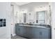 Double vanity bathroom with granite countertops and grey cabinets at 10721 Ayear Rd, Port Charlotte, FL 33981