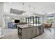 Open kitchen with a large island, stainless steel appliances, and grey cabinets at 10721 Ayear Rd, Port Charlotte, FL 33981