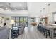 Open living space with gray tile floors, recessed lighting, and sliding doors to pool at 10721 Ayear Rd, Port Charlotte, FL 33981