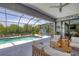 Relaxing pool area with covered patio, outdoor kitchen, and seating at 10721 Ayear Rd, Port Charlotte, FL 33981