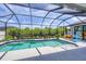 Inviting screened pool and spa with lounge chairs at 10721 Ayear Rd, Port Charlotte, FL 33981
