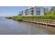 Waterfront boardwalk path with modern building view at 1375 Beach Rd # 210, Englewood, FL 34223