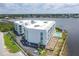 Aerial view of a modern waterfront building with pool and parking at 1375 Beach Rd # 210, Englewood, FL 34223