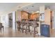 Kitchen with light wood cabinets, granite counters, and breakfast bar at 1375 Beach Rd # 210, Englewood, FL 34223