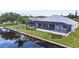 Home boasts a travertine pool deck and concrete seawall at 15267 Appleton Blvd, Port Charlotte, FL 33981