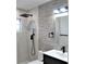 Modern bathroom with gray tile and black fixtures at 15267 Appleton Blvd, Port Charlotte, FL 33981