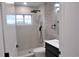 Modern bathroom with gray tile and black fixtures at 15267 Appleton Blvd, Port Charlotte, FL 33981