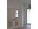 Bright entryway with mirrored doors and modern light fixture at 15267 Appleton Blvd, Port Charlotte, FL 33981
