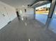 Clean garage with gray epoxy flooring, utility door, and automatic garage door opener at 15267 Appleton Blvd, Port Charlotte, FL 33981