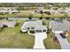 Aerial view of a single-Gathering home with a three-car garage and canal views at 261 Broadmoor Ln, Rotonda West, FL 33947