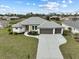 Single-Gathering home with three-car garage and landscaped yard at 261 Broadmoor Ln, Rotonda West, FL 33947