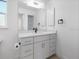 Modern bathroom with a white vanity and a large mirror at 261 Broadmoor Ln, Rotonda West, FL 33947