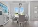 Spacious dining room with large windows and white furniture at 261 Broadmoor Ln, Rotonda West, FL 33947
