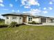 Single-story home with a three-car garage, and attractive landscaping at 261 Broadmoor Ln, Rotonda West, FL 33947