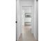 Clean hallway with light walls and tile flooring at 261 Broadmoor Ln, Rotonda West, FL 33947