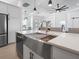 Modern kitchen with a farmhouse sink and stainless steel appliances at 261 Broadmoor Ln, Rotonda West, FL 33947