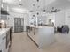 Open kitchen with white cabinets, large island, and stainless steel appliances at 261 Broadmoor Ln, Rotonda West, FL 33947