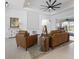 Relaxing living room with two brown leather sofas at 261 Broadmoor Ln, Rotonda West, FL 33947