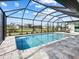 Spacious screened-in pool with a view of the backyard at 261 Broadmoor Ln, Rotonda West, FL 33947