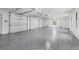 Large three-car garage with epoxy flooring and high ceilings at 7161 Manasota Key Rd, Englewood, FL 34223