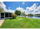 Grass lawn, canal view, and dock with seating at 544 Lindley Ter, Port Charlotte, FL 33952