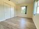 Bedroom with vinyl flooring, window, and double-door closet at 544 Lindley Ter, Port Charlotte, FL 33952