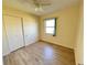 Bedroom with vinyl flooring, window, and closet at 544 Lindley Ter, Port Charlotte, FL 33952