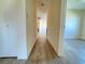 Light-filled hallway with wood-look flooring connecting the rooms at 544 Lindley Ter, Port Charlotte, FL 33952