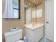 Guest bathroom with toilet, vanity, and mirrored medicine cabinet at 7293 Spinnaker Blvd, Englewood, FL 34224