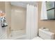 Bright bathroom with tub and shower, white vanity, and window at 7293 Spinnaker Blvd, Englewood, FL 34224