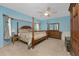 Main bedroom with post bed and light blue walls at 7293 Spinnaker Blvd, Englewood, FL 34224