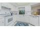 White kitchen with updated countertops and corner sink at 7293 Spinnaker Blvd, Englewood, FL 34224