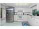 Stainless steel appliances and white cabinetry in this kitchen at 7293 Spinnaker Blvd, Englewood, FL 34224