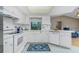 White kitchen with stainless steel appliances and tile floor at 7293 Spinnaker Blvd, Englewood, FL 34224