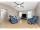 Living room with hardwood floors, comfortable seating, and a ceiling fan at 7293 Spinnaker Blvd, Englewood, FL 34224