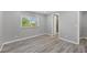 Spacious bedroom with wood-look floors and access to bathroom at 740 Summersea Ct, Englewood, FL 34223