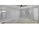 Bedroom with window, ceiling fan, and wood-look floors at 740 Summersea Ct, Englewood, FL 34223