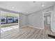 Bright living room with luxury vinyl plank flooring and an adjacent screened porch for indoor/outdoor living at 740 Summersea Ct, Englewood, FL 34223