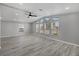 Open-concept living room featuring vaulted ceilings, a ceiling fan, and large windows for abundant natural light at 740 Summersea Ct, Englewood, FL 34223