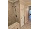 Updated bathroom with walk-in shower, built-in seat, and neutral tile at 881 Bayshore Dr, Englewood, FL 34223