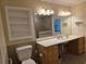 Main bathroom with vanity, toilet, and built-in shelving at 881 Bayshore Dr, Englewood, FL 34223