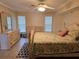 Bright bedroom featuring a king-size bed, dresser, and large windows at 881 Bayshore Dr, Englewood, FL 34223