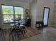 Bright dining area with table and chairs, view of the front yard at 881 Bayshore Dr, Englewood, FL 34223