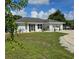 Landscaped yard and newly painted home at 881 Bayshore Dr, Englewood, FL 34223