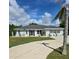 Single-story house with a landscaped yard and driveway at 881 Bayshore Dr, Englewood, FL 34223