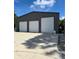 Three-car garage with roll-up doors at 881 Bayshore Dr, Englewood, FL 34223