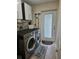 Laundry room with washer, dryer, and cabinets at 881 Bayshore Dr, Englewood, FL 34223