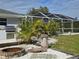 Relaxing poolside area with fire pit at 881 Bayshore Dr, Englewood, FL 34223