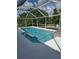 Inviting screened-in pool and spa with ample deck space at 881 Bayshore Dr, Englewood, FL 34223