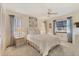 Bright bedroom with a queen-size bed and neutral decor at 101 Pebble Rock Dr, Venice, FL 34293